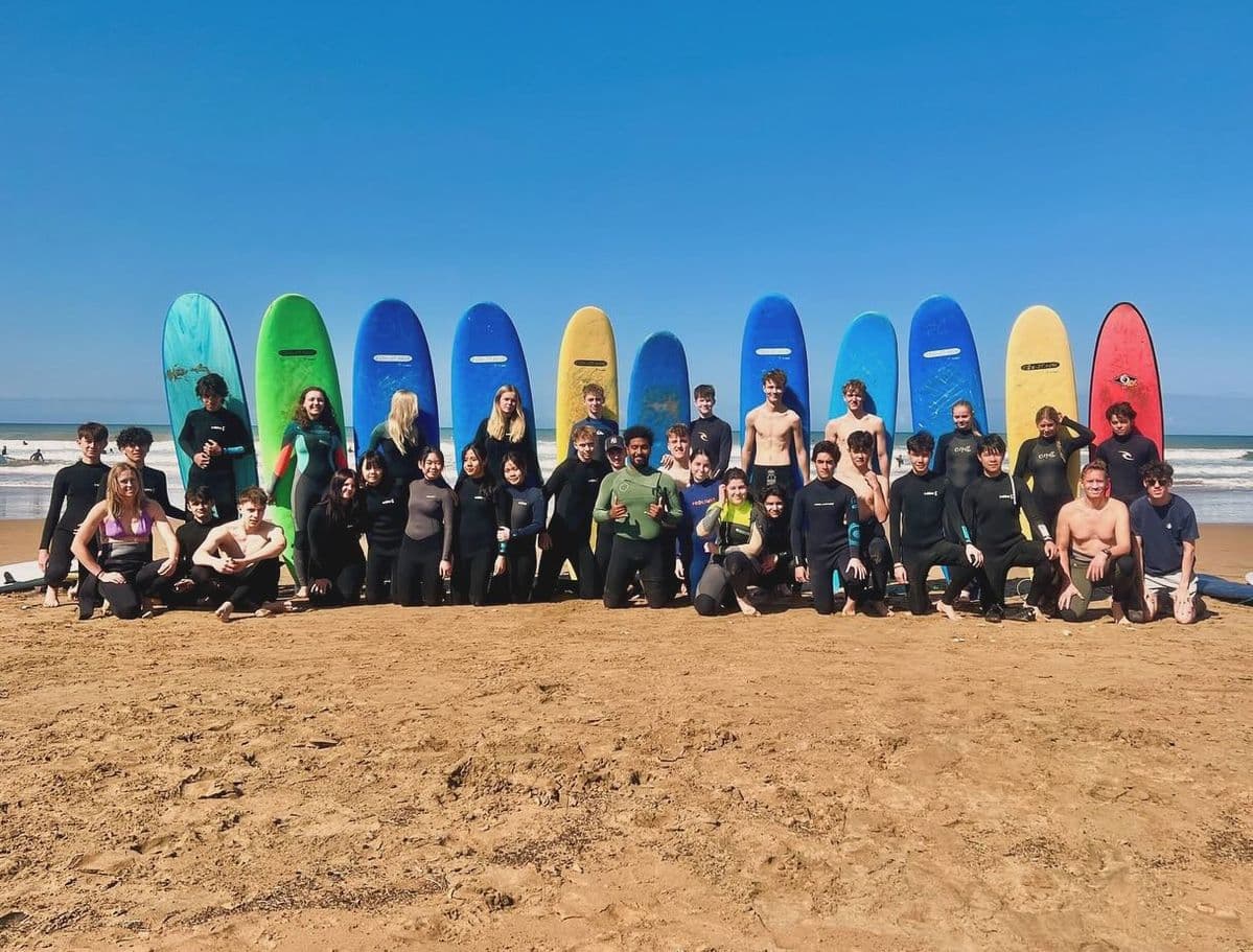 Surfboards lined up on the beach at a Taghazout surf school