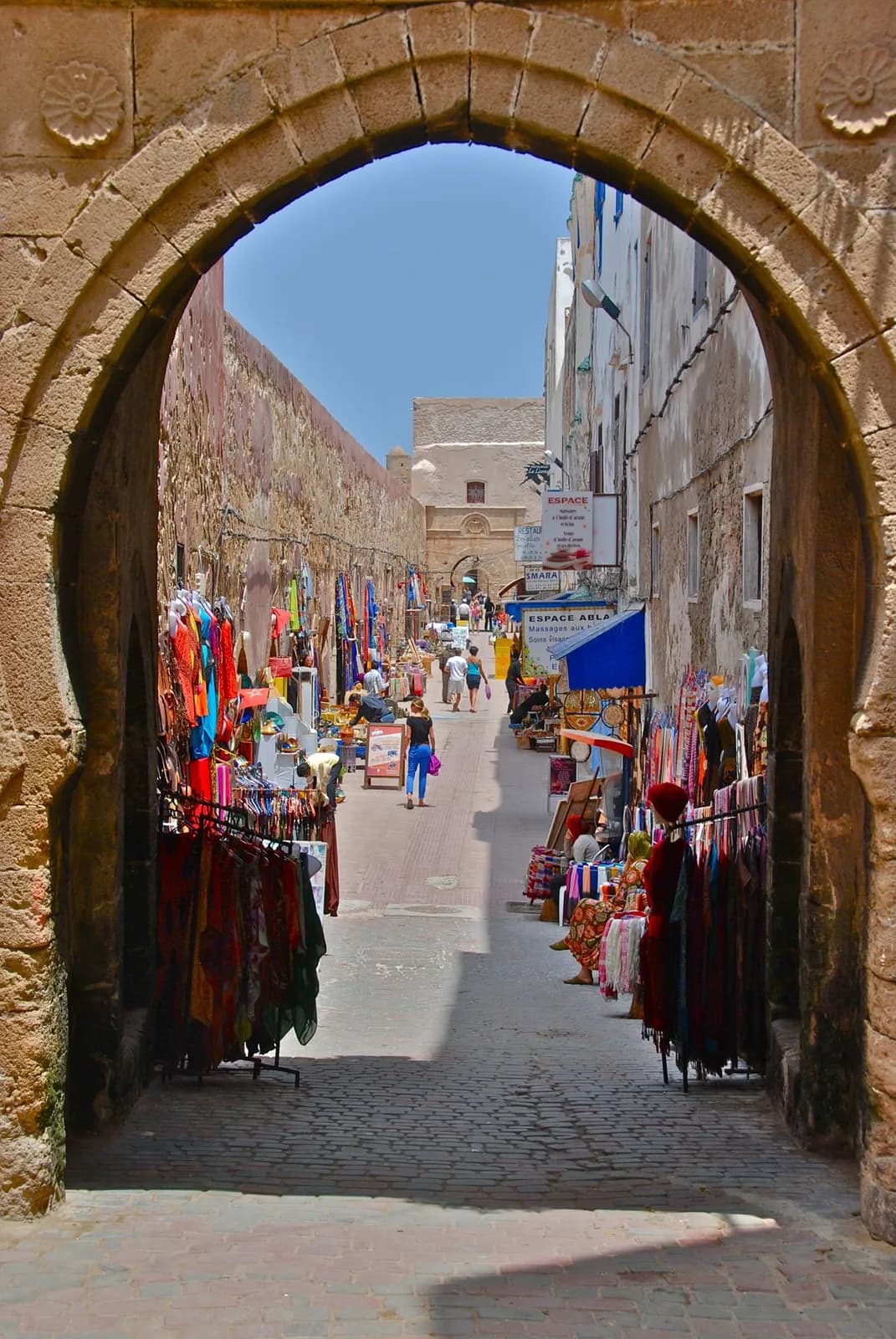 A colourful souk lane through the medina gate, Essaouira