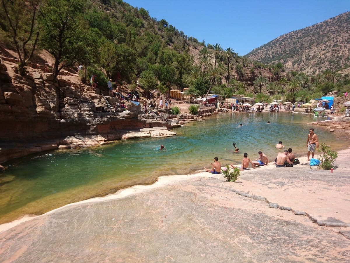 Turquoise natural rock pools of Paradise Valley framed by palm trees